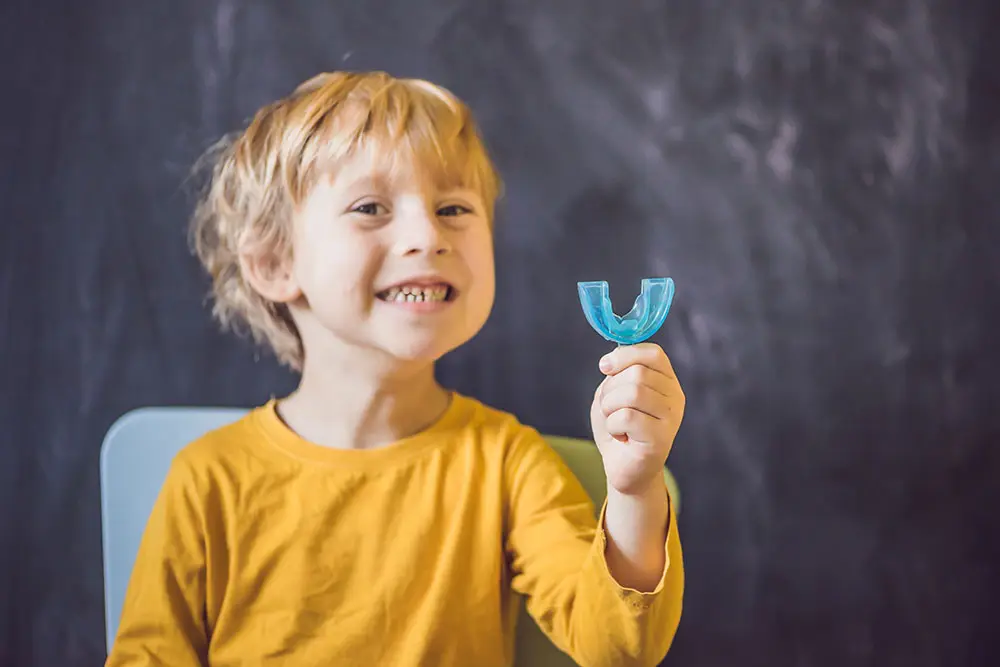 little boy with a mouthguard