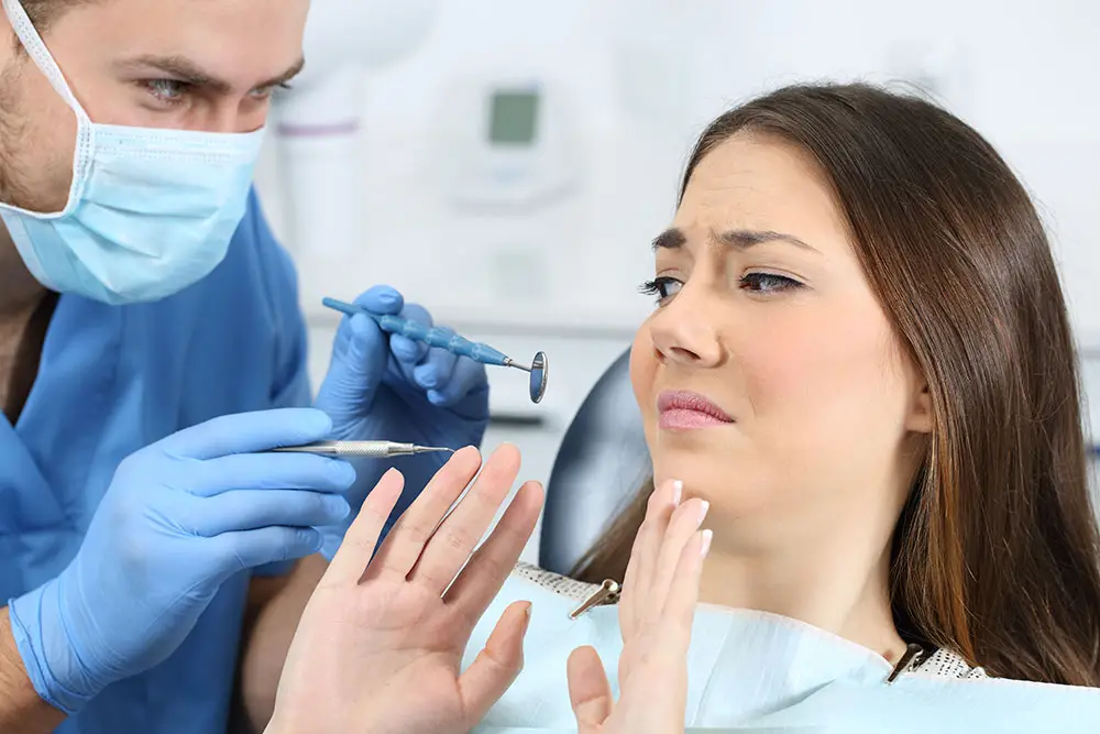 Girl scared to receive dental treatment