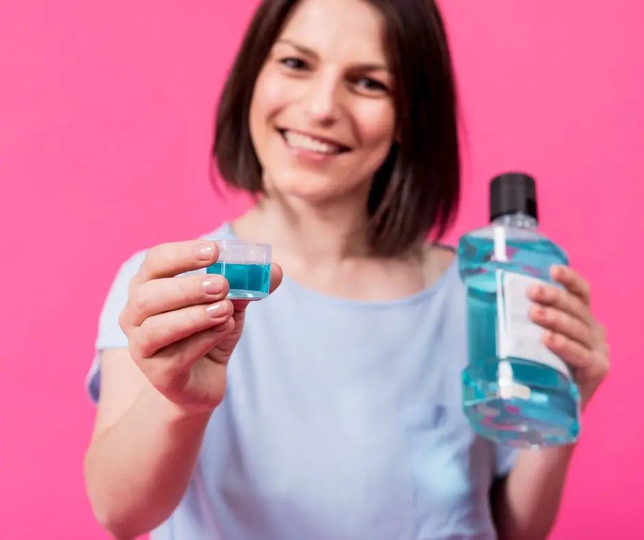 girl using mouthwash